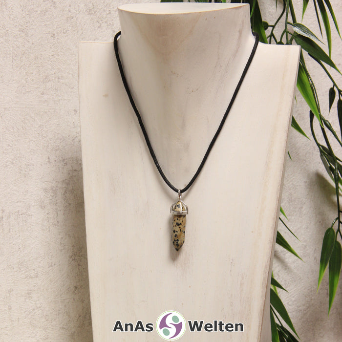 Ein Dalmatinerstein Stift-Anhänger groß mit Metallöse, der mit einem schwarzen Baumwollband um eine helle Büste gehängt wurde