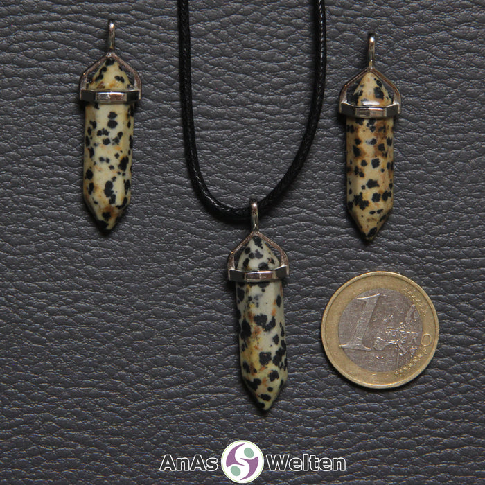 Drei Doppelspitze Stift-Anhänger aus Dalmatinerstein nebeneinander. Einer befindet sich an einem schwarzen Baumwollband.