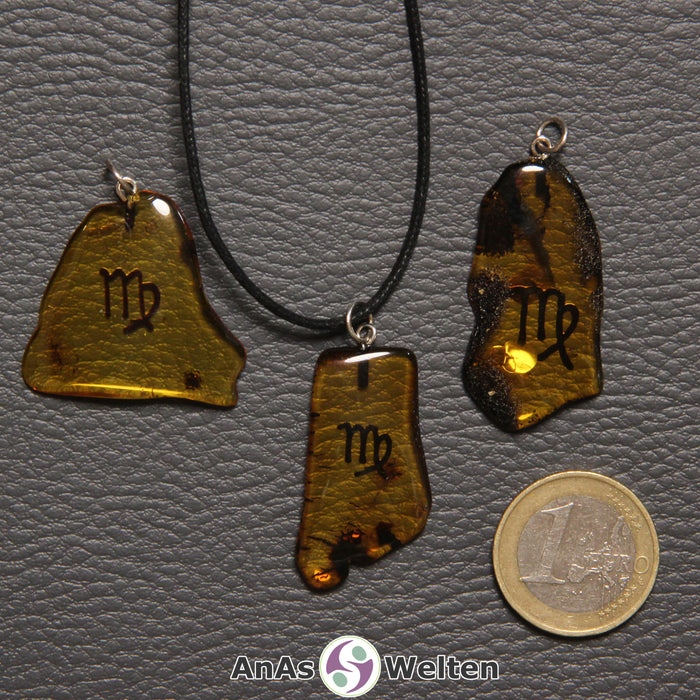 Drei Bernstein Anhänger Jungfrau in verschiedenen Formen. Das Sternzeichensymbol ist in die Bernsteine eingebrannt.