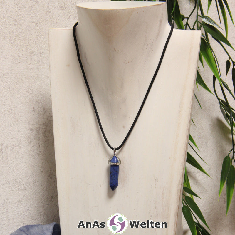 Ein Dumortierit Stift-Anhänger groß mit Metallöse, der mit einem schwarzen Baumwollband um eine helle Büste gehängt wurde