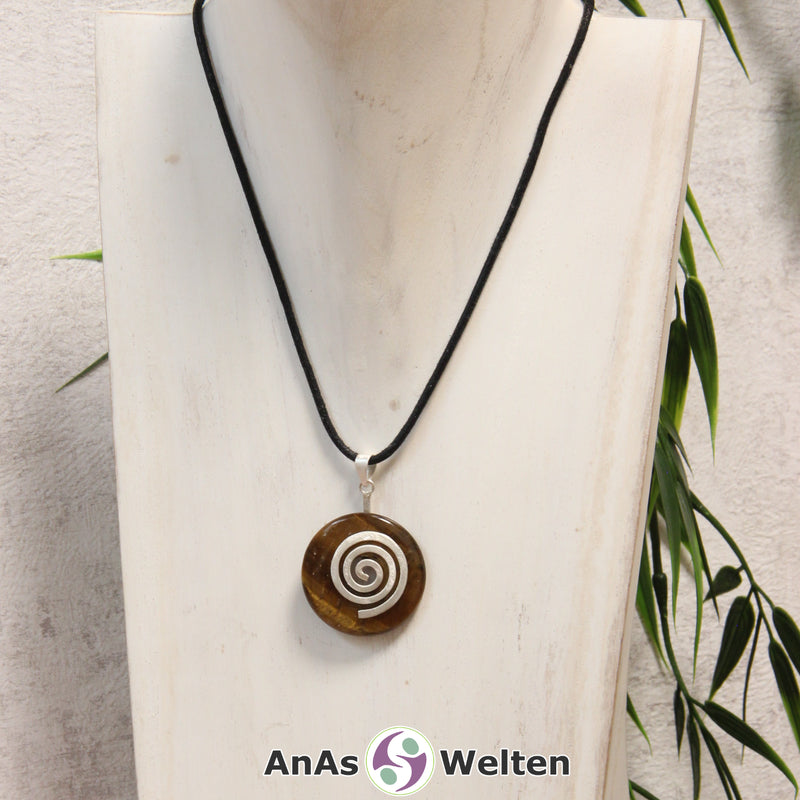 Ein Tigerauge Donut an einem Donut-Halter Spirale, der mit einem gewachsten Baumwollband um eine helle Büste hängt.